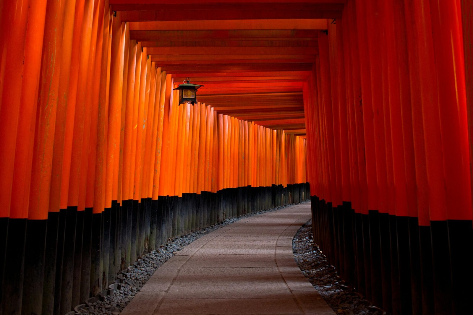 Gray Concrete Pathway Between Red-and-black Pillars